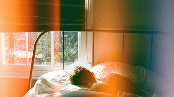 Homepage canva   person lying in bed beside window